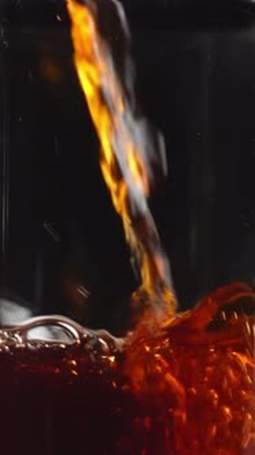 Pouring a Refreshing Beverage Into a Stylish Glass Pitcher for Enjoyment and Presentation Media
