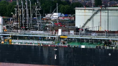 Oil Tanker Ship Offloading Fuel at a Port and Depot