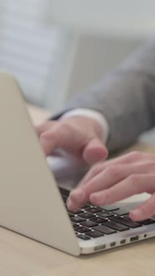 Close up of Male Hands Typing on Laptop, vertical video