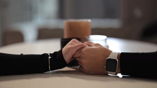 Close Up of a Couple Holding Hands Tenderly