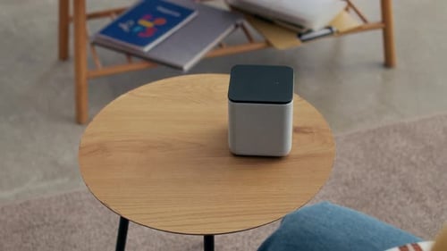 Woman Relaxing with Smart Speaker Nearby