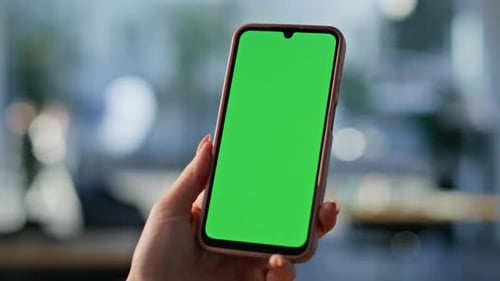 Manicured Finger Tapping Green Screen Smartphone at Workplace Office Closeup