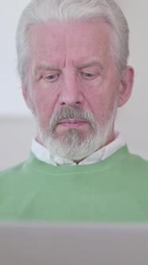 Close Up of Old Man working on Laptop, vertical video