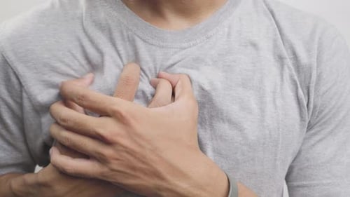 Health concept man holding his right chest