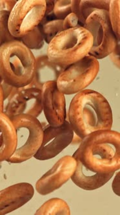 The Steering Wheel Crackers Fly Up and Fall on a Light Background Filmed on a Highspeed Camera at