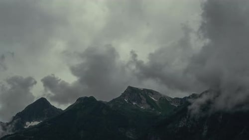 Mountain Peaks in Clouds Cloudy Dark Weather Fog Moving Fast at Dusk Dramatic Landscape