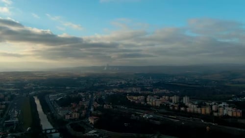 aerial view of Pine trees forest on cold winter morning with early warm sunlight european city