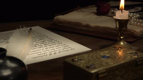 Candle Lit Scene of Vintage Letter and Book