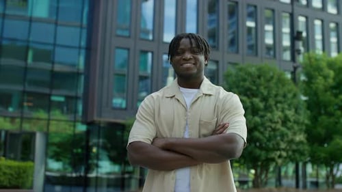 Smiling Man Posing Outdoors in Urban Setting