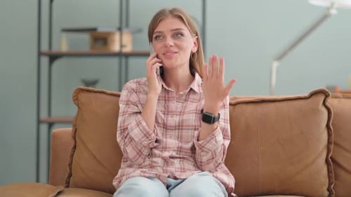 Woman Talking on the Phone Sitting on Couch