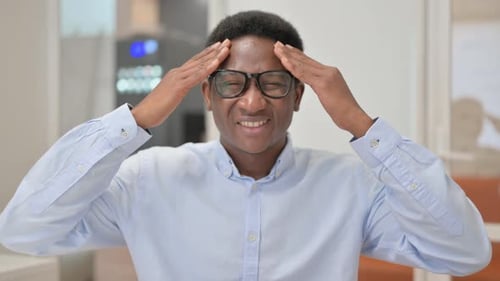 Portrait of African Businessman with Headache in Office