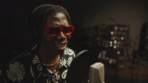 Stylish Black Singer in Headphones Performing in Music Recording Studio