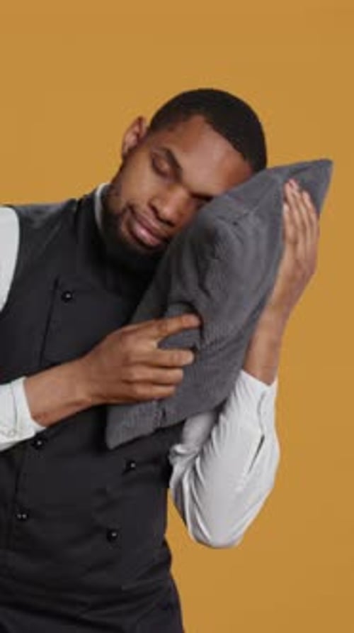Vertical Video Professional Fatigued Waiter Takes a Nap on His Pillow After Night Shift
