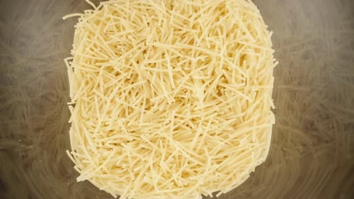 The camera inside in a glass jar with noodles. Dolly slider extreme close-up inside. Laowa Probe