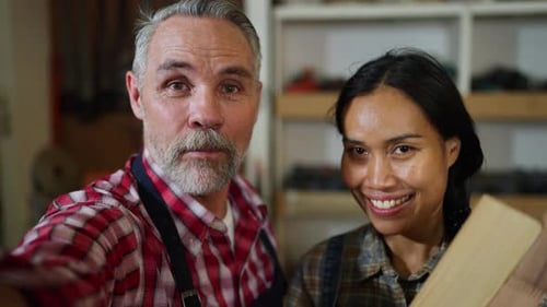 Couple carpenter man and woman express selfie with mobile phone and hold by man to introduce producr