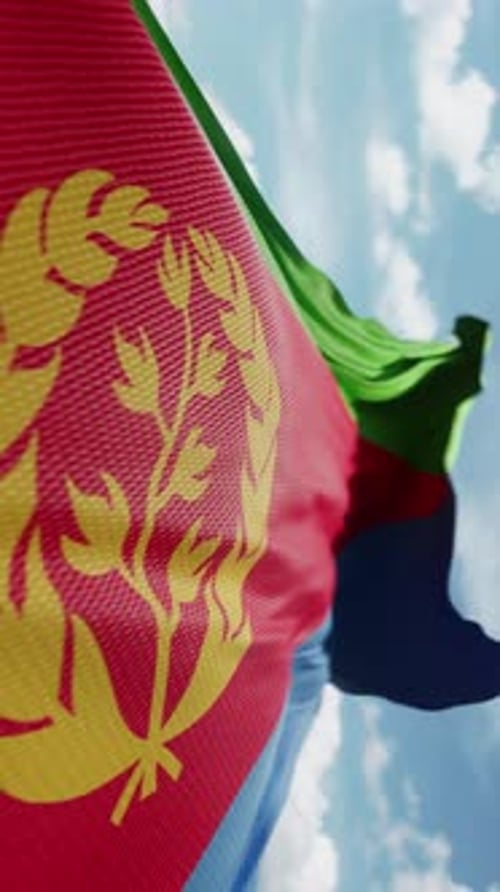 Realistic Eritrea National Flag Waving Against Blue Sky