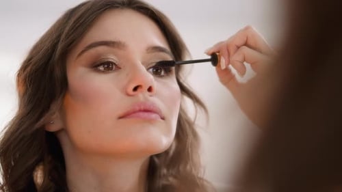 Woman Applying Mascara for Makeup Tutorial
