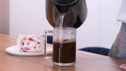 Brewing Coffee with Cake Slice on Table