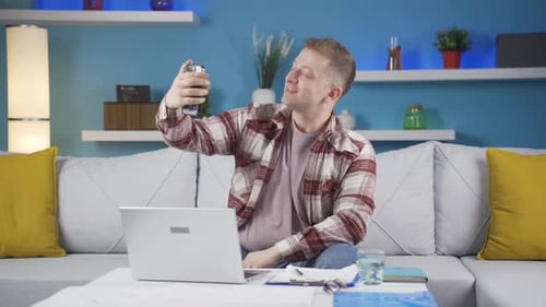 Home office worker man talking on the phone facetime happily.