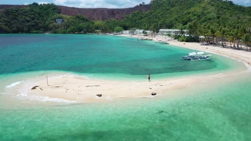 Aerial View of Man on White Sandbar and Woman Swimming in Tropical Sea. Romblon Island Arhipelago, P