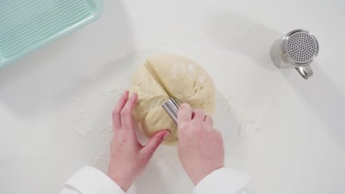 Hands Divide and Shape Dough for Baking