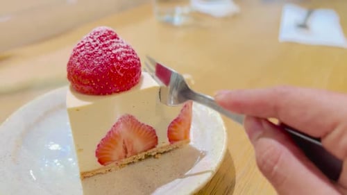 Cutting a Slice of Delicious Strawberry Cheesecake