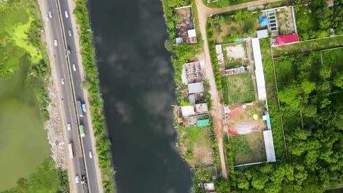 Vehicles are moving from a beautiful road in Dhaka city nearby a lake