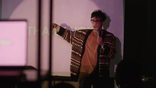 Man Giving Presentation at Corporate Event with Microphone
