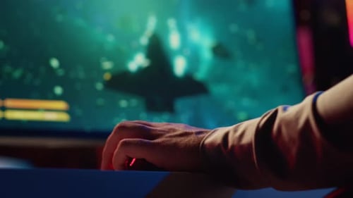 Man Using Gaming Keyboard to Play Spaceship Flying Singleplayer Game