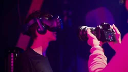 Shooting video with VR games in a studio with blue pink neon lights