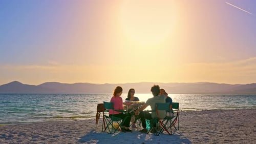 Friends Sitting Beach at Sunset