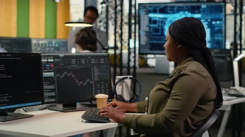 Woman Types at Computer in Office Workplace