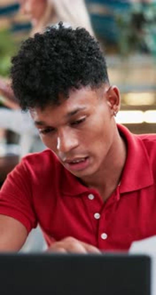 Student, man and talking with laptop, documents and reading at university with online course