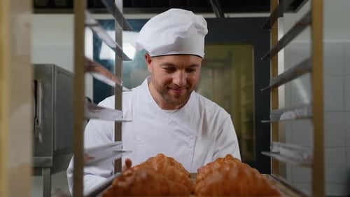 Baker with Croissants in Commercial Kitchen