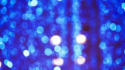 Blurred light spots seamless loop circle color bokeh lights background. defocused lens light
