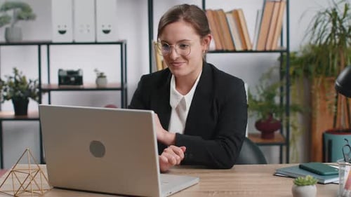 Caucasian Business Woman Sitting at Office Workplace Desk Closing Laptop After Finishing Remote Work