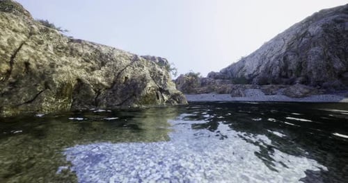 Clear Water Reflects Rocky Shoreline and Serene Sky at Quiet Cove