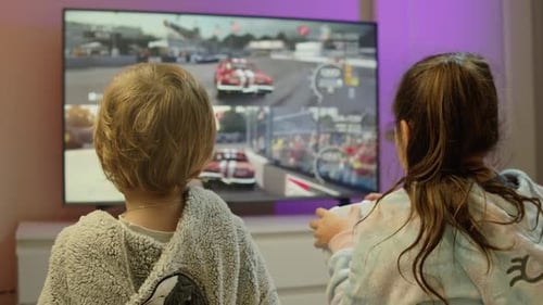 Happy Siblings Playing Video Games And Enjoying Vacation Time Together