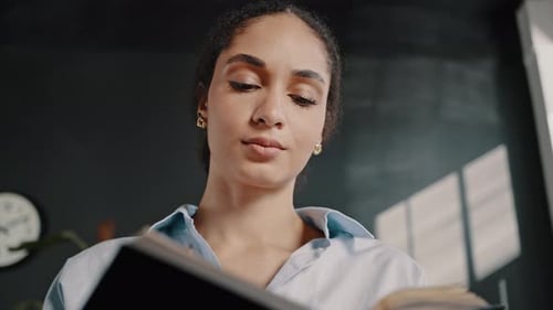 Woman Reading and Thinking in Office Environment