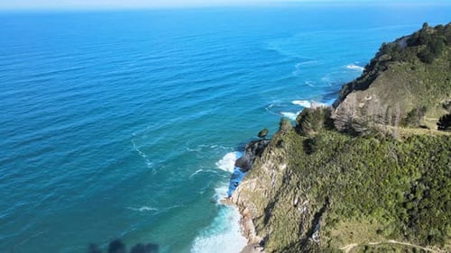 Wide rising drone shot of a small section of the New Zealand coastline. 4k 59.94p
