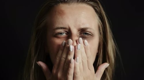 Distraught Woman Crying in Close-Up on Dark Background