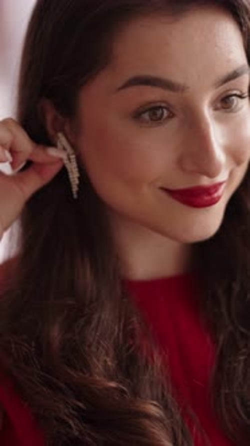 Woman Putting on Earrings, Close Up Portrait