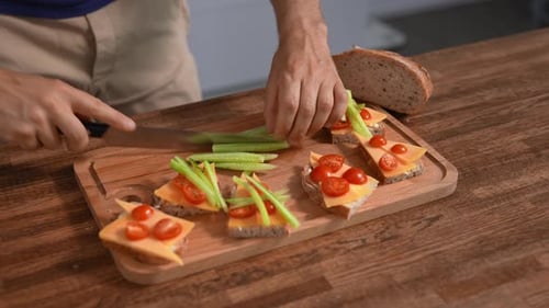 Man Making Fresh Vegetable Sandwiches on Bread