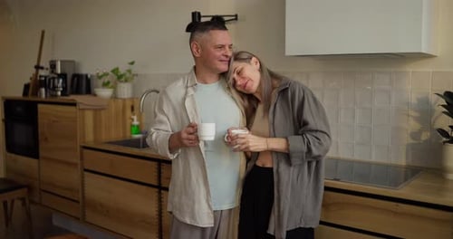 Loving Couple Together in Kitchen Drinking Coffee
