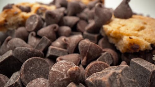 Chocolate chip tower with cookie pieces and chocolate chips falling macro close up push in zoom in 4