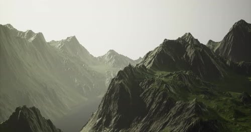 Majestic Mountain Range Under Soft Sunlight in a Serene Landscape