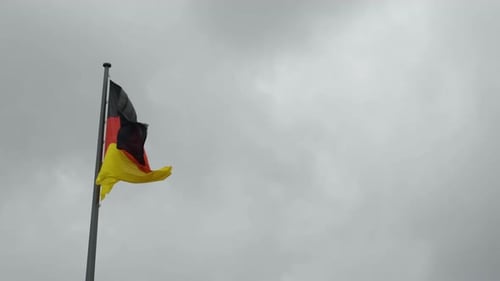 German Flag Waving Against Cloudy Sky