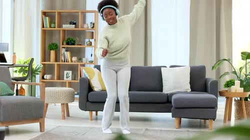 Woman Dancing and Listening to Music at Home