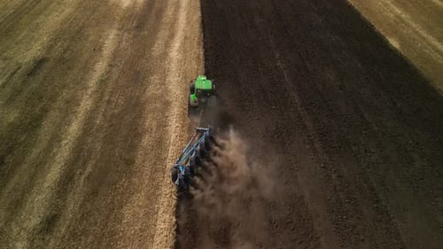 Tractors plowing the field in Ukraine