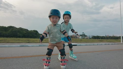 Kids learn roller skating. Two kids boy and girl learn roller skating in the urban safe area and do